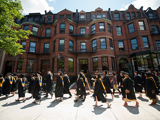 Students walk along Newbury St. during the Commencement Processional. 