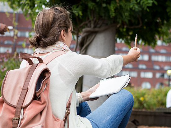 girl sketching at a park